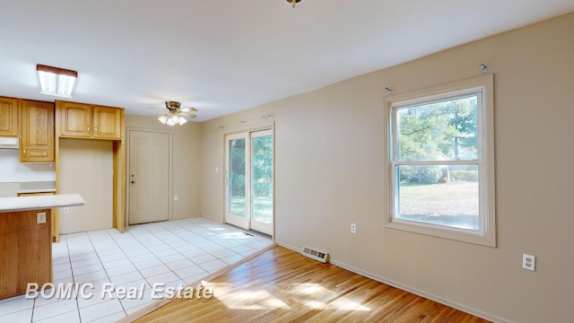 kitchen featuring light hardwood / wood-style floors, extractor fan, and ceiling fan