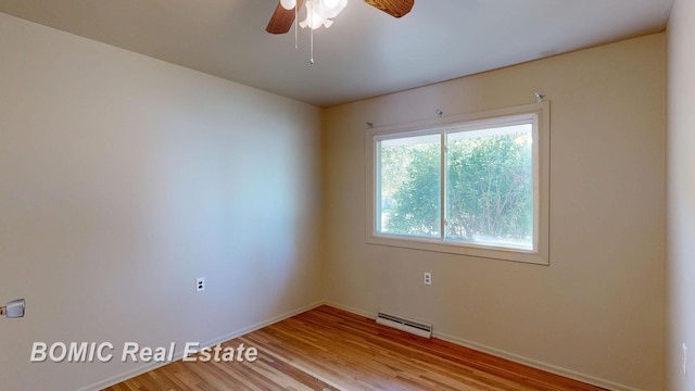 empty room with ceiling fan, light wood-type flooring, and baseboard heating