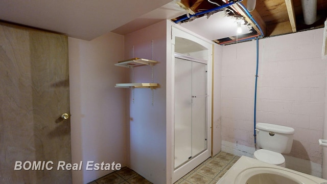 bathroom featuring toilet and walk in shower