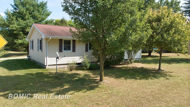 view of property exterior with a yard