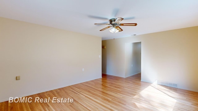 spare room with ceiling fan and light wood-type flooring