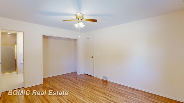 unfurnished bedroom featuring a closet, light hardwood / wood-style floors, and ceiling fan