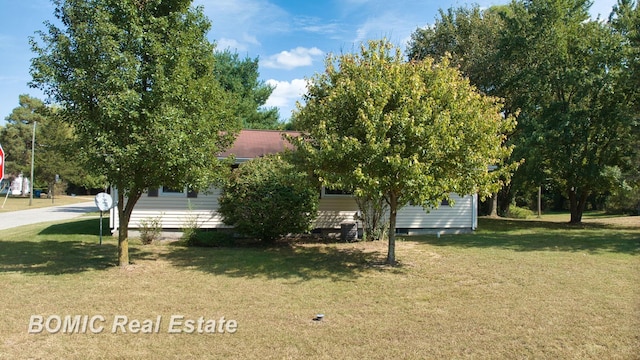 view of property exterior with a lawn