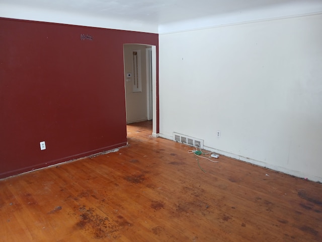 unfurnished room with wood-type flooring