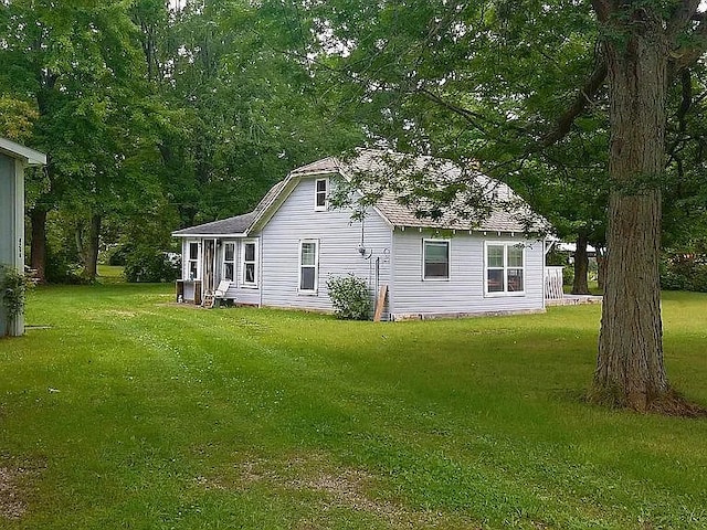 rear view of property with a lawn