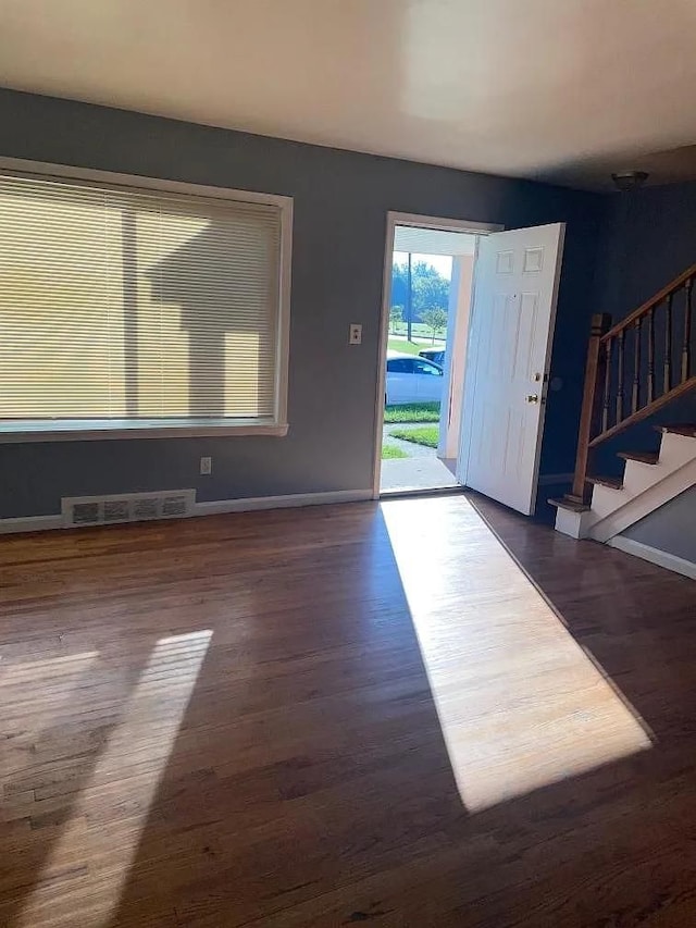 entryway with dark hardwood / wood-style floors