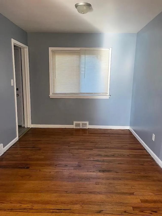 spare room with dark hardwood / wood-style floors