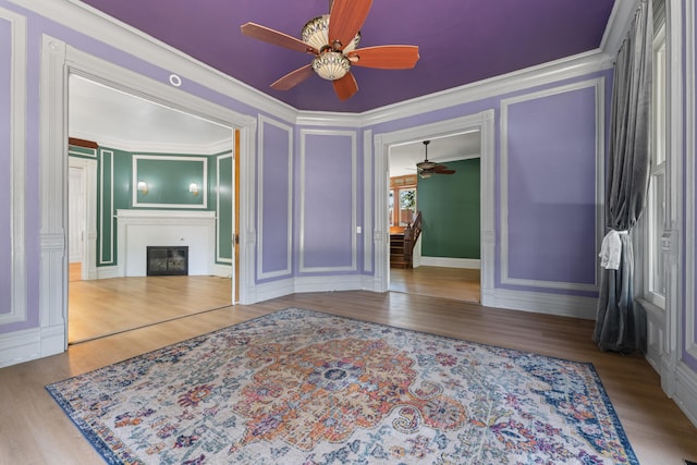 bedroom featuring a closet, light hardwood / wood-style flooring, ceiling fan, and crown molding