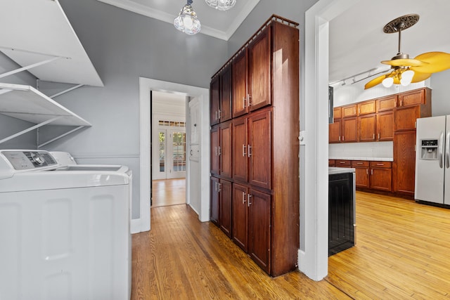 laundry room featuring washer and dryer, crown molding, ceiling fan, and light hardwood / wood-style floors