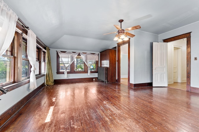 unfurnished living room with lofted ceiling, plenty of natural light, ceiling fan, and dark hardwood / wood-style floors