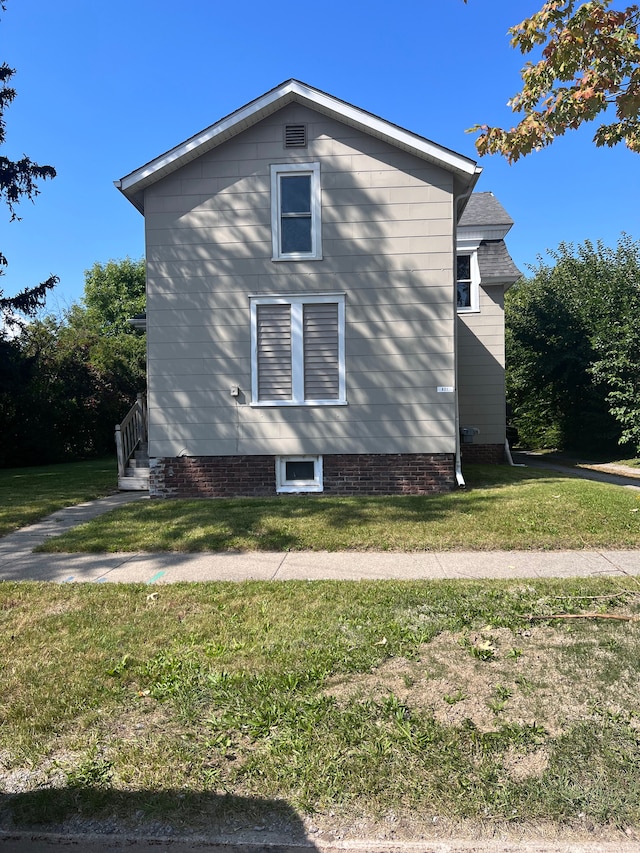 view of property exterior featuring a lawn