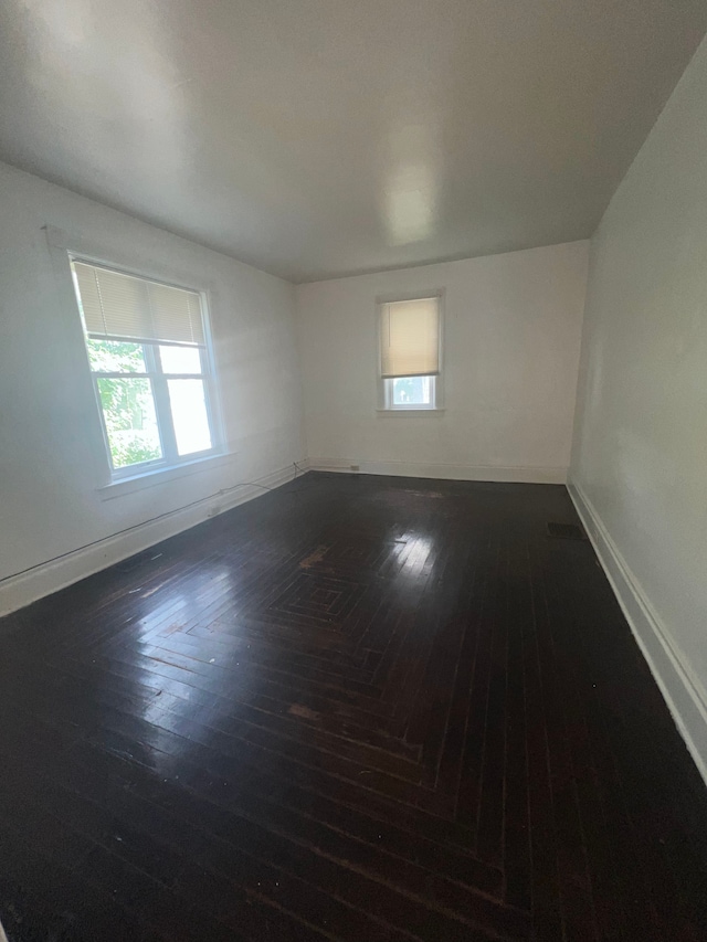 unfurnished room featuring dark hardwood / wood-style floors