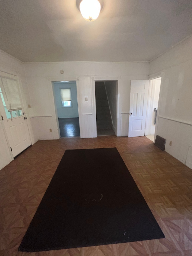 entrance foyer featuring dark parquet flooring