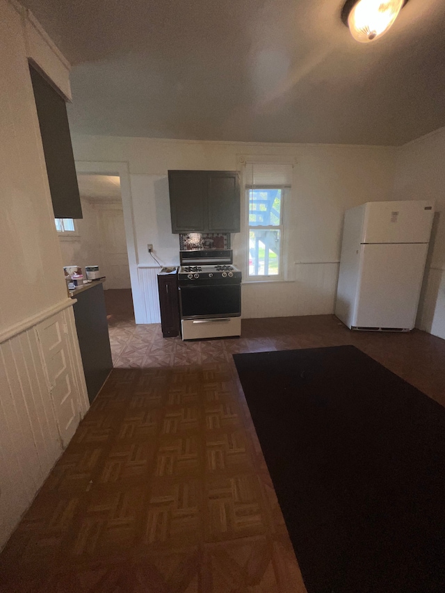 kitchen featuring dark parquet flooring and white appliances