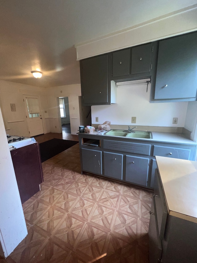 kitchen featuring sink and light parquet floors