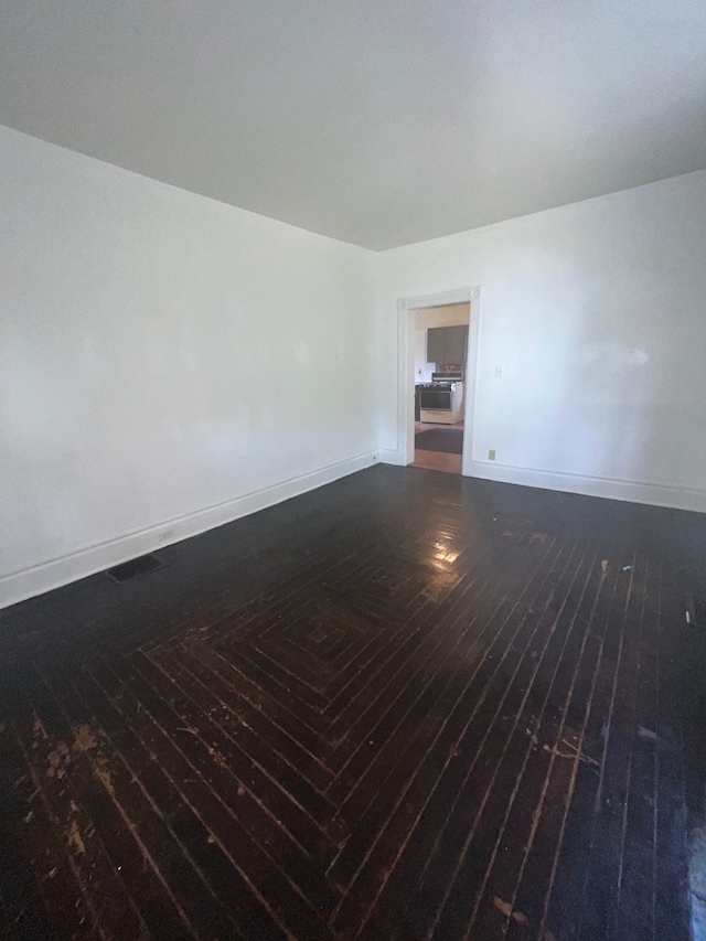 spare room with dark hardwood / wood-style floors