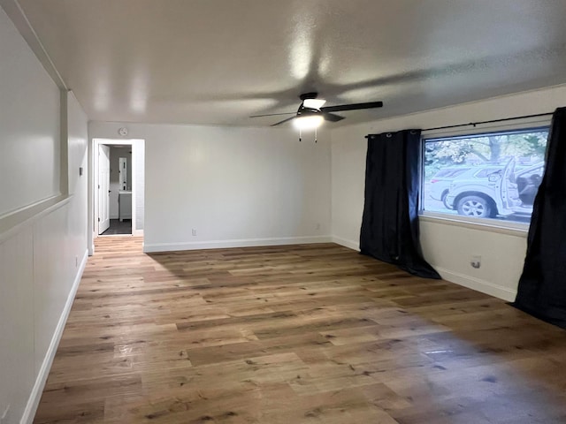 spare room with ceiling fan and hardwood / wood-style floors