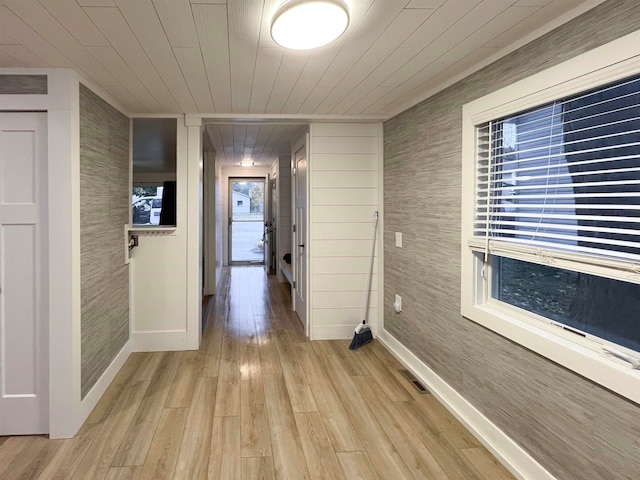 corridor with wood ceiling and light hardwood / wood-style floors