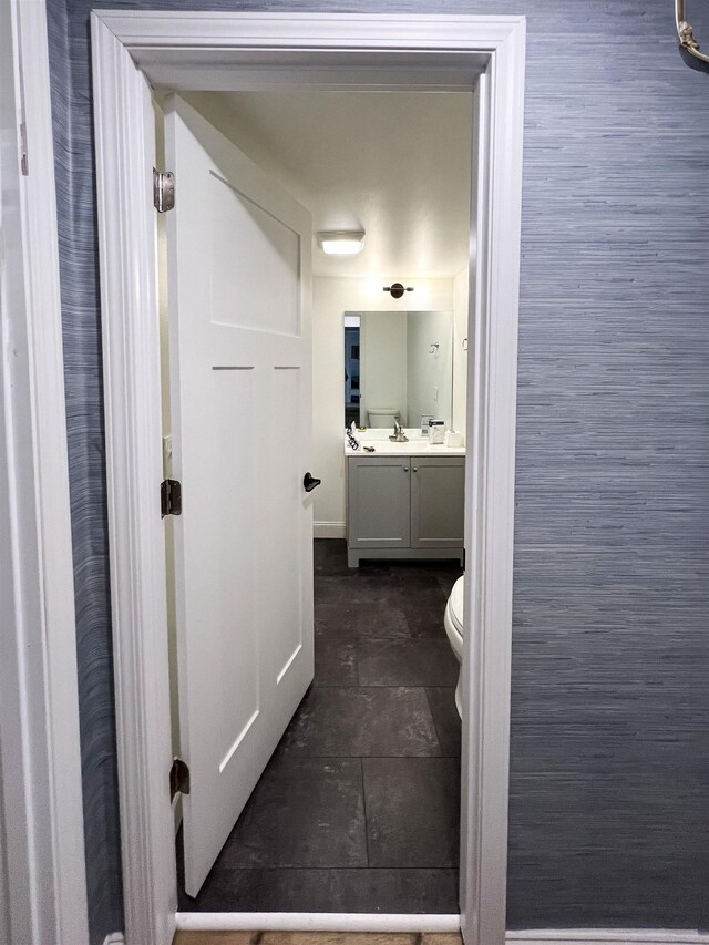 120 N Cedar St, Traverse City, MI 49684 - bathroom featuring vanity, toilet, and stone finish floors