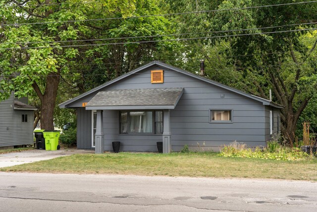 TBB120 N Cedar St, Traverse City, MI 49684 - view of front of property with a shingled roof and a front yard