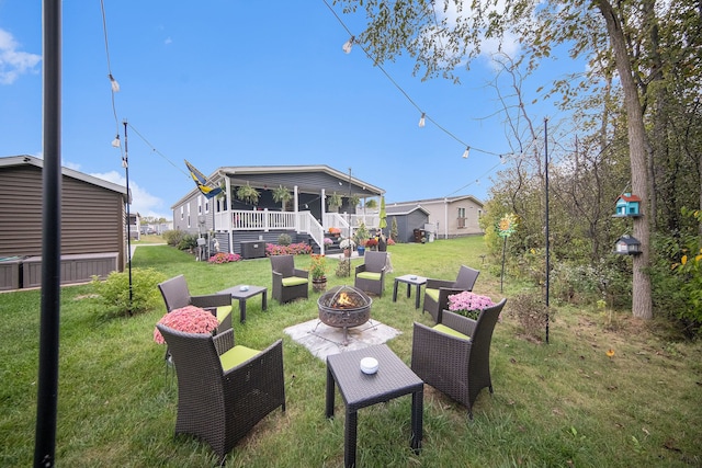 view of yard featuring an outdoor living space with a fire pit