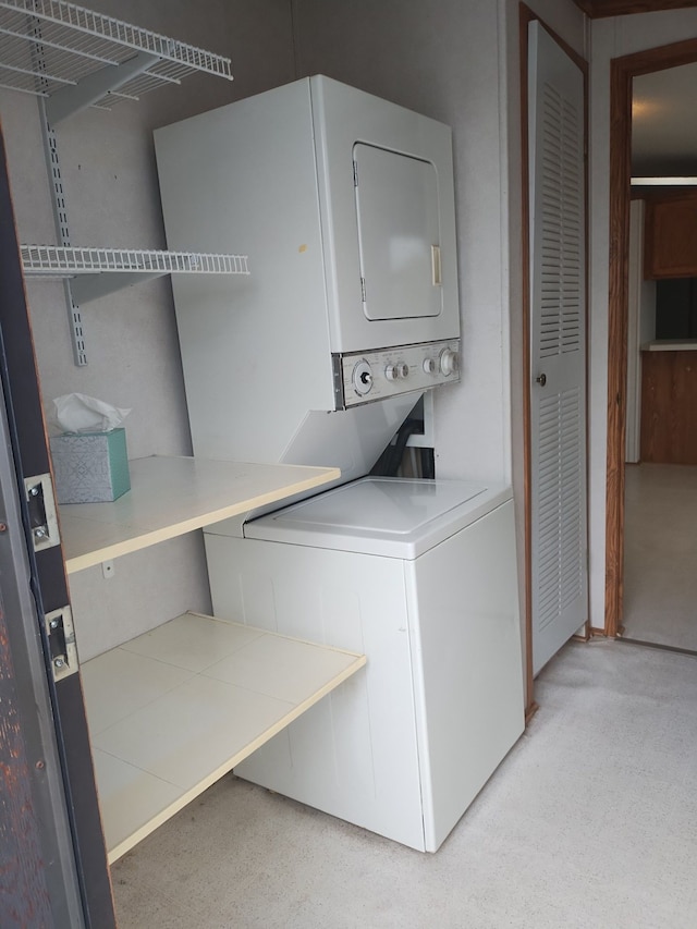 laundry area featuring stacked washer and clothes dryer