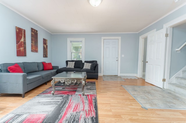 living room with crown molding and hardwood / wood-style floors