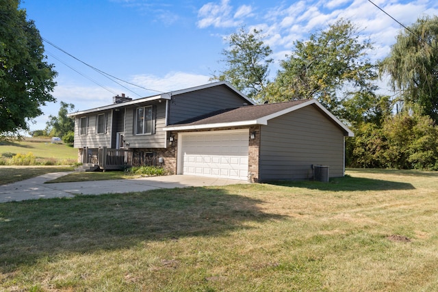 view of front facade featuring central AC, a garage, and a front lawn