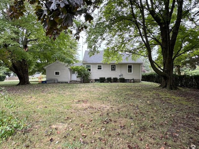 back of property featuring a lawn