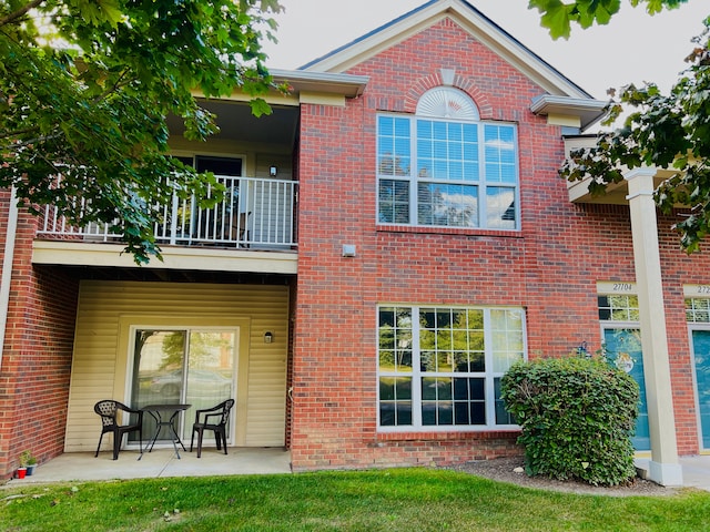 back of property featuring a balcony