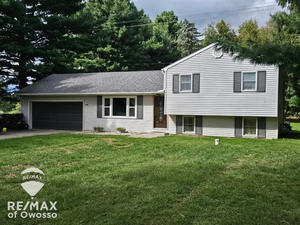 split level home with a garage and a front yard