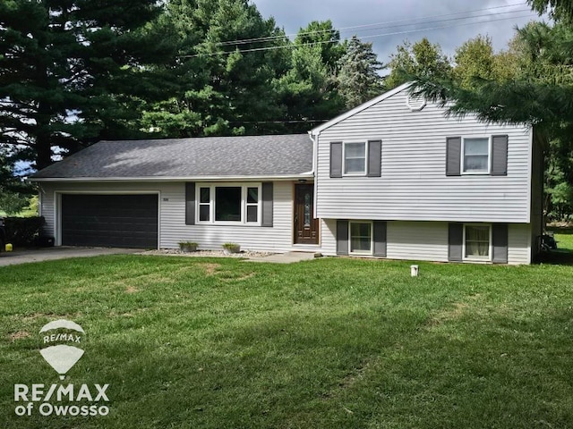 split level home with a garage and a front yard