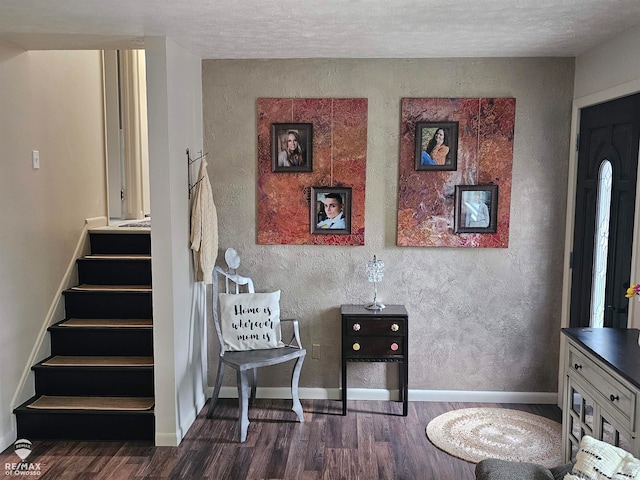 sitting room featuring a textured ceiling and dark hardwood / wood-style floors