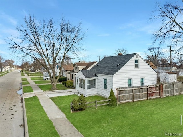 rear view of property featuring a yard