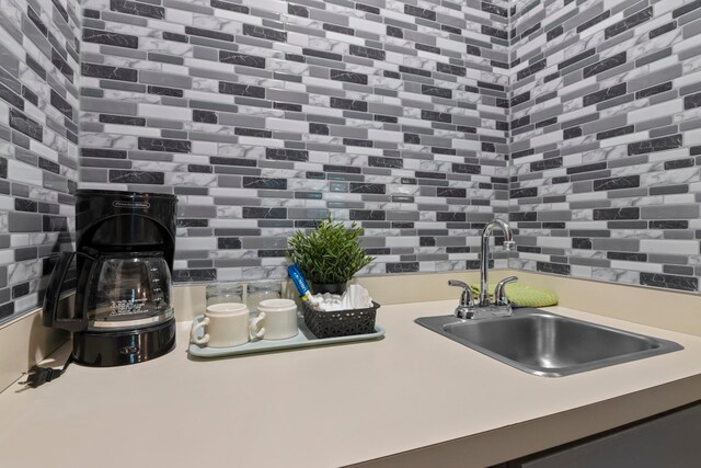 5830 Shanty Creek Rd, Bellaire, MI 49615 - kitchen view of a sink, decorative backsplash, and light countertops