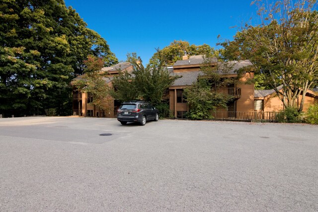 5830 Shanty Creek Rd, Bellaire, MI 49615 - obstructed view of property with uncovered parking and a chimney