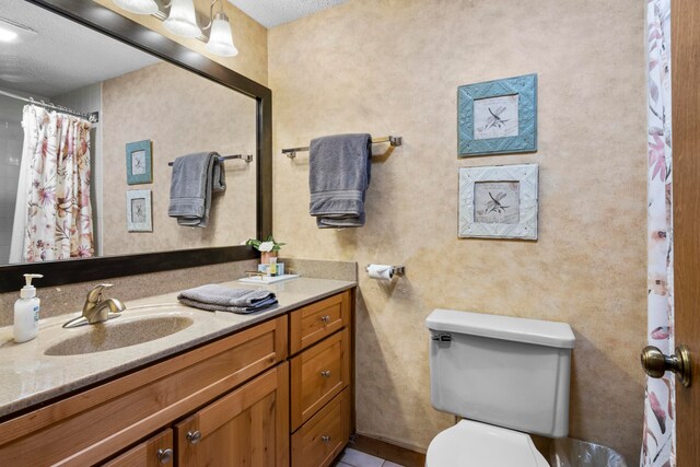 5830 Shanty Creek Rd, Bellaire, MI 49615 - full bath with vanity, toilet, and tile patterned flooring