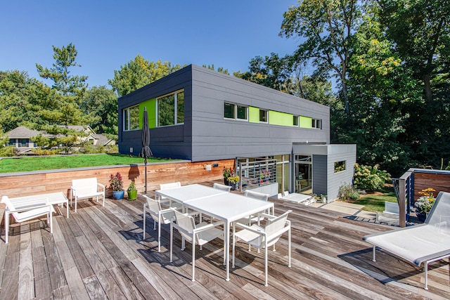 wooden terrace featuring outdoor dining area