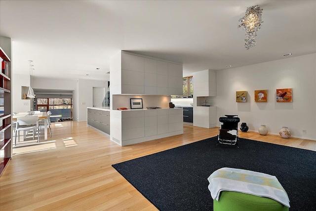 living area featuring light wood-style flooring and baseboards