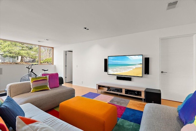 living room featuring visible vents and light wood-style flooring
