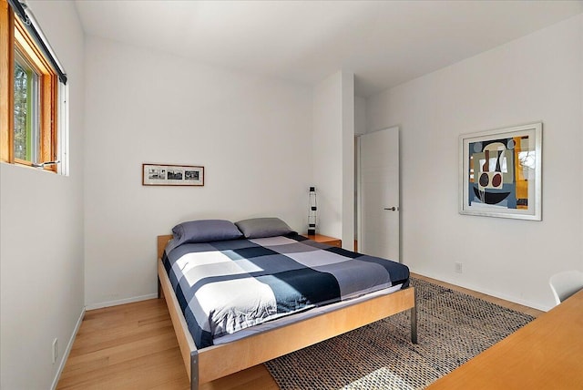 bedroom featuring light wood-style flooring and baseboards