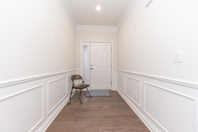 doorway to outside with ornamental molding and dark hardwood / wood-style floors