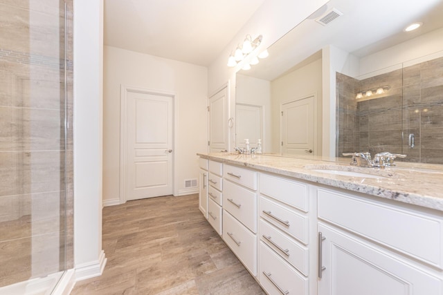 bathroom with vanity, hardwood / wood-style floors, and walk in shower