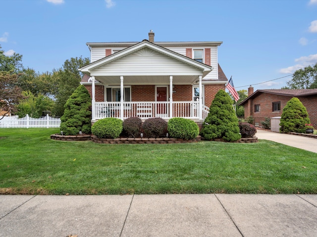 view of front facade featuring a porch and a front yard