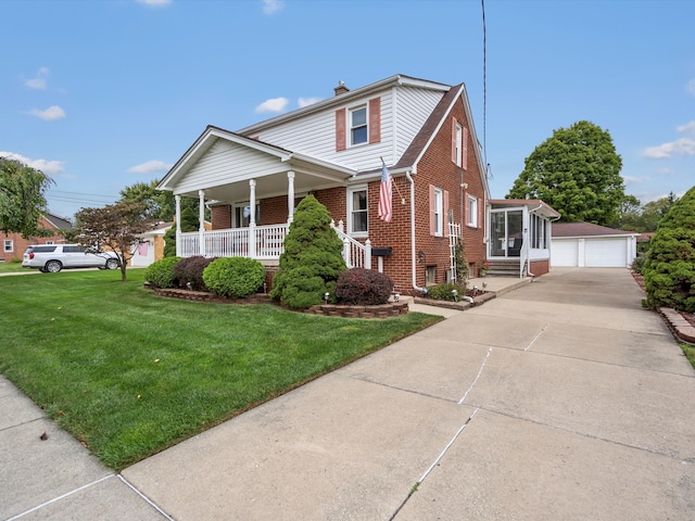 view of front of property with an outbuilding, a front yard, and a garage