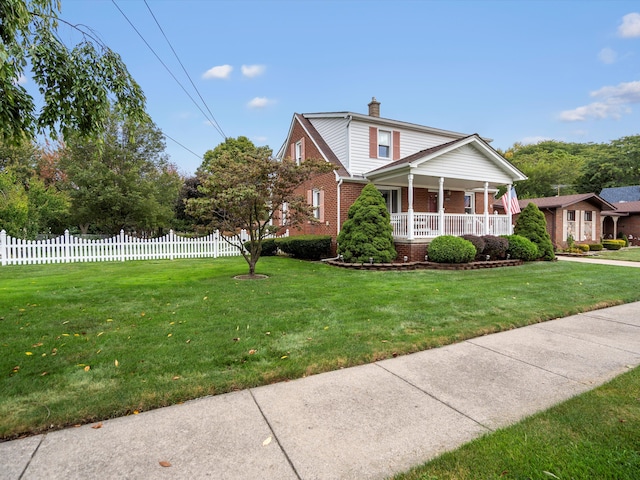 view of front of home with covered porch and a front yard