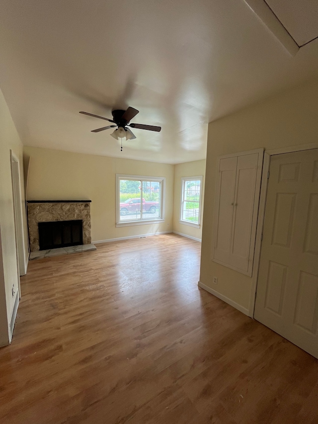 unfurnished living room featuring ceiling fan and light hardwood / wood-style flooring