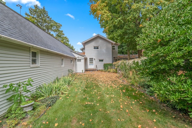 rear view of property featuring a lawn