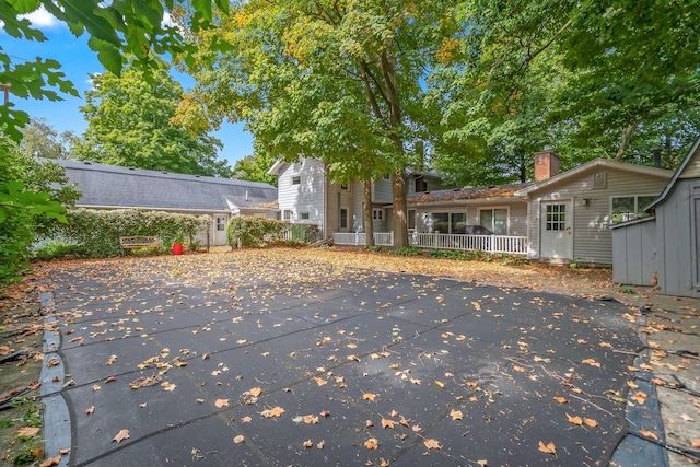 back of property featuring a patio and a pool