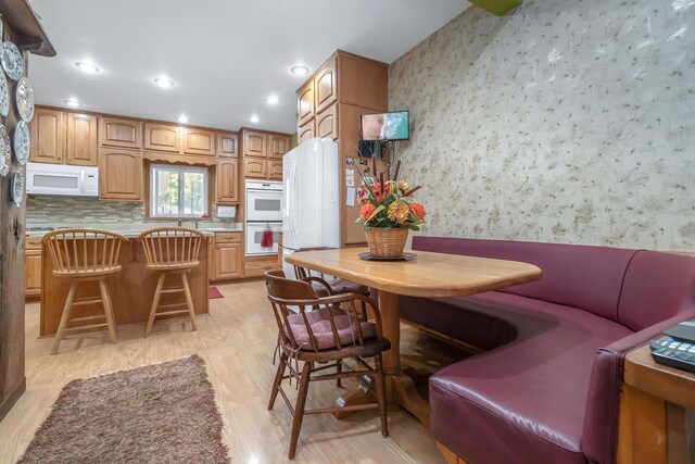89 E Chicago St, Quincy, MI 49082 - dining room featuring wallpapered walls, light wood-style flooring, and recessed lighting